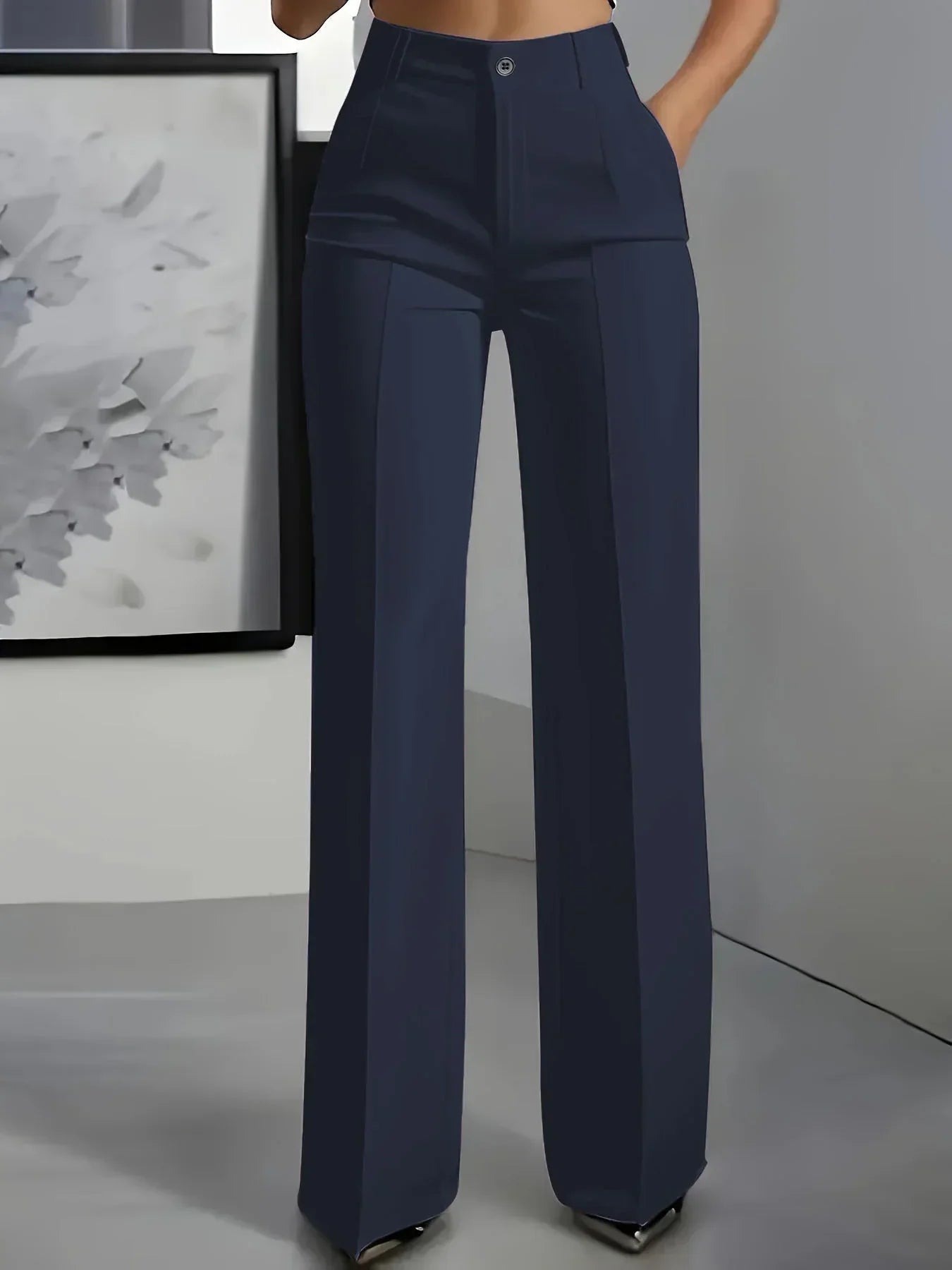 Side angle of women's wide leg trousers highlighting high rise and relaxed fit