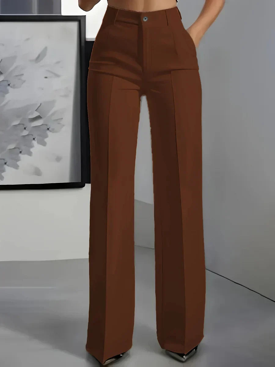 Detail shot of side pockets and front pleat construction on high waist trousers
