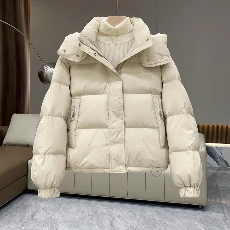 Close-up of women's hooded puffer jacket high neck and adjustable hood drawcord