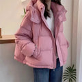 Side angle of women's black hooded puffer jacket with quilted panels and zip closure