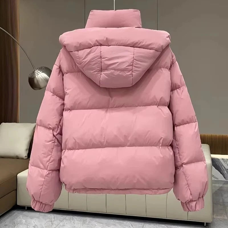 Full-length view of women's black hooded puffer jacket with oversized fit and practical details