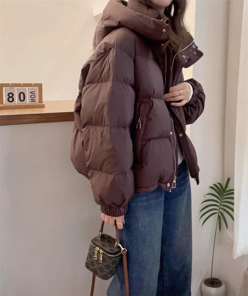 Detail of women's hooded puffer jacket side pocket and quilted construction