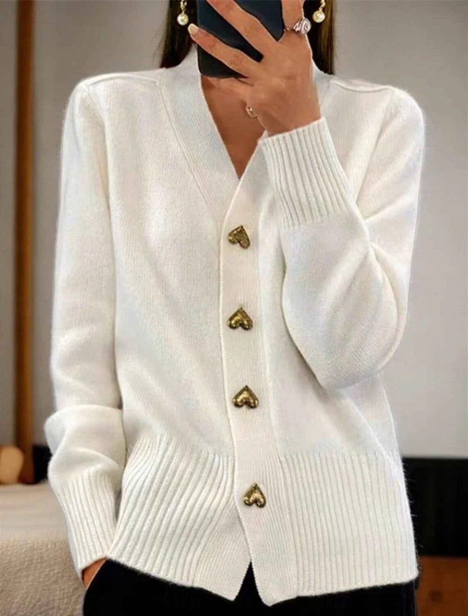Side view of women's hip-length knit cardigan showing relaxed fit and ribbed cuffs detail