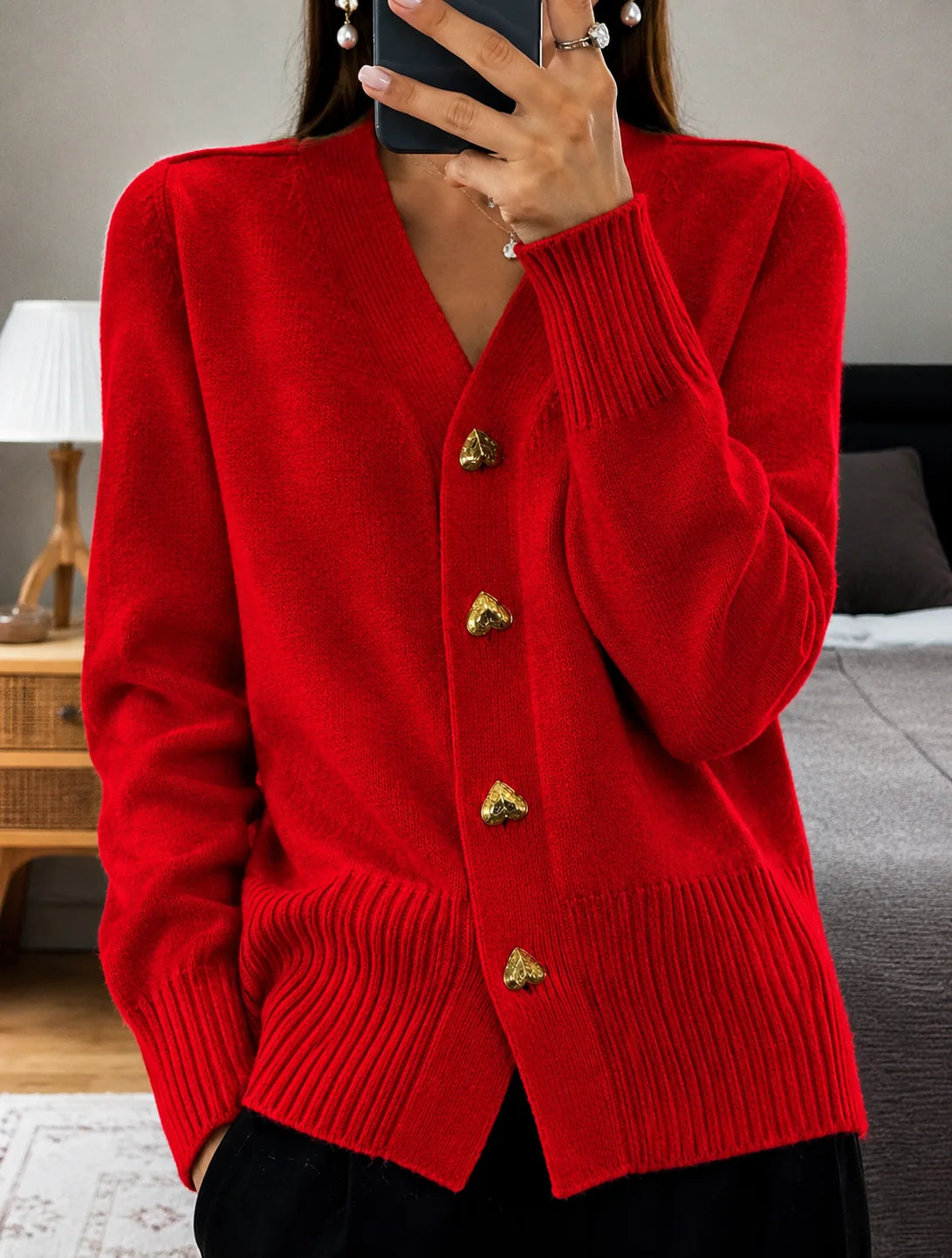 Back view of women's fine knit cardigan displaying relaxed fit and ribbed hem construction