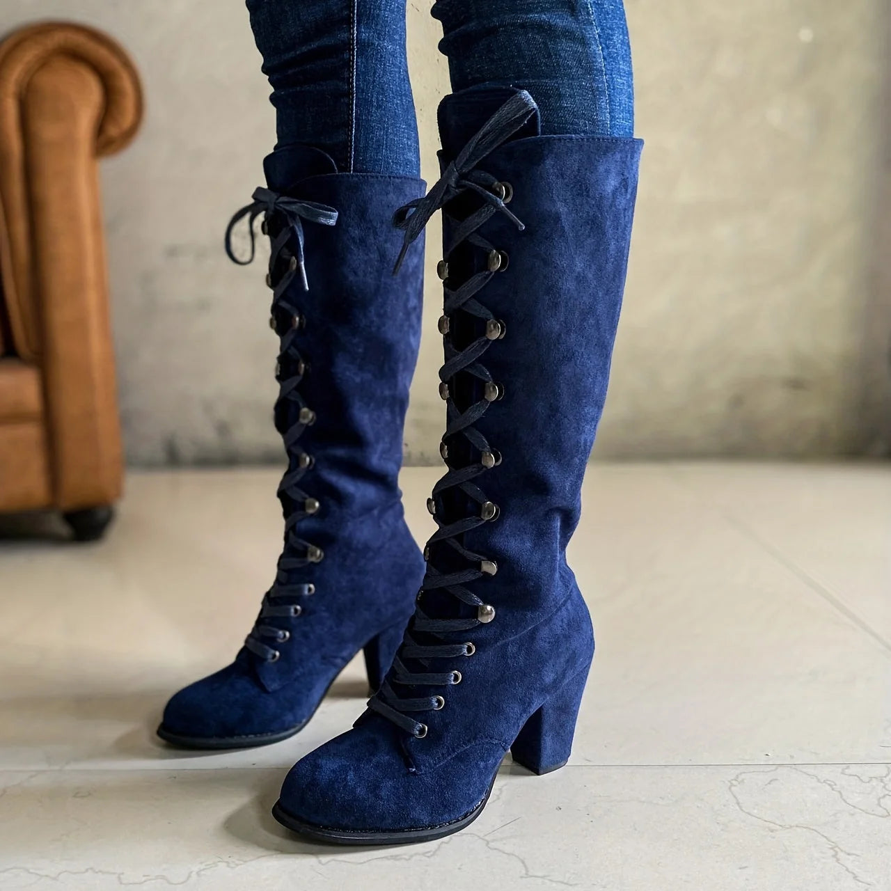Side angle of women's knee-high lace-up boots with suede-effect finish and stable heel