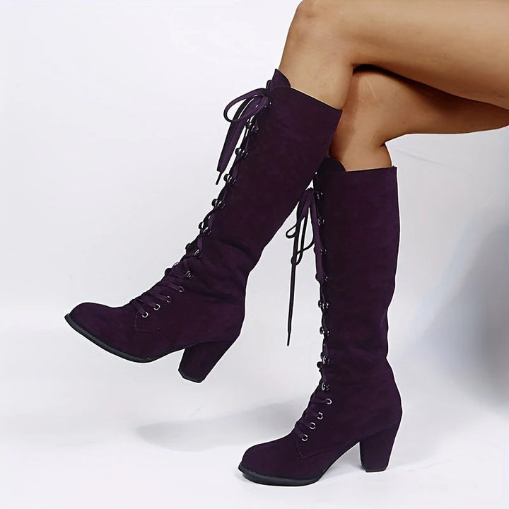 Side view of women's knee-high boots showing full-length lacing and chunky heel construction