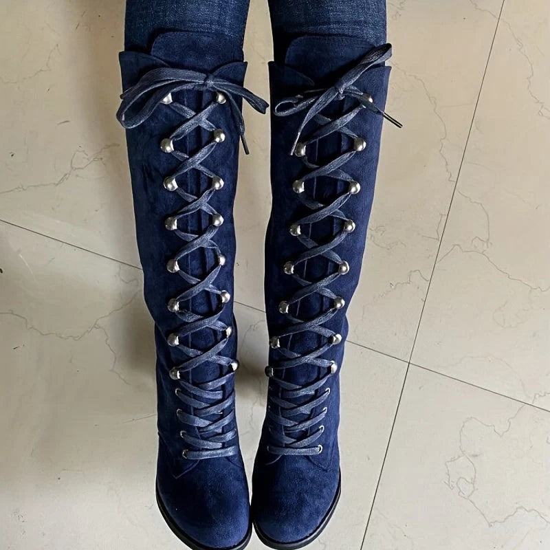 Close-up of lace-up detail on women's knee-high boots with adjustable fit