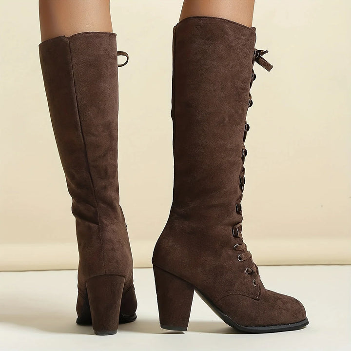 Detail of block heel and suede-effect finish on women's lace-up knee-high boots