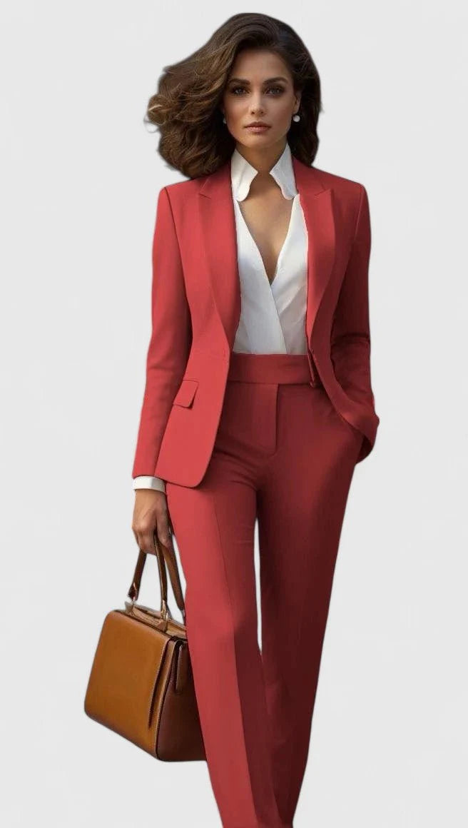 Women's tailored suit set with coral-red blazer and matching trousers styled with white shirt
