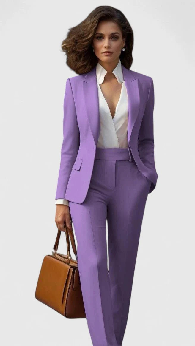 Full-length view of women's tailored suit set in coral-red with coordinated blazer and trousers