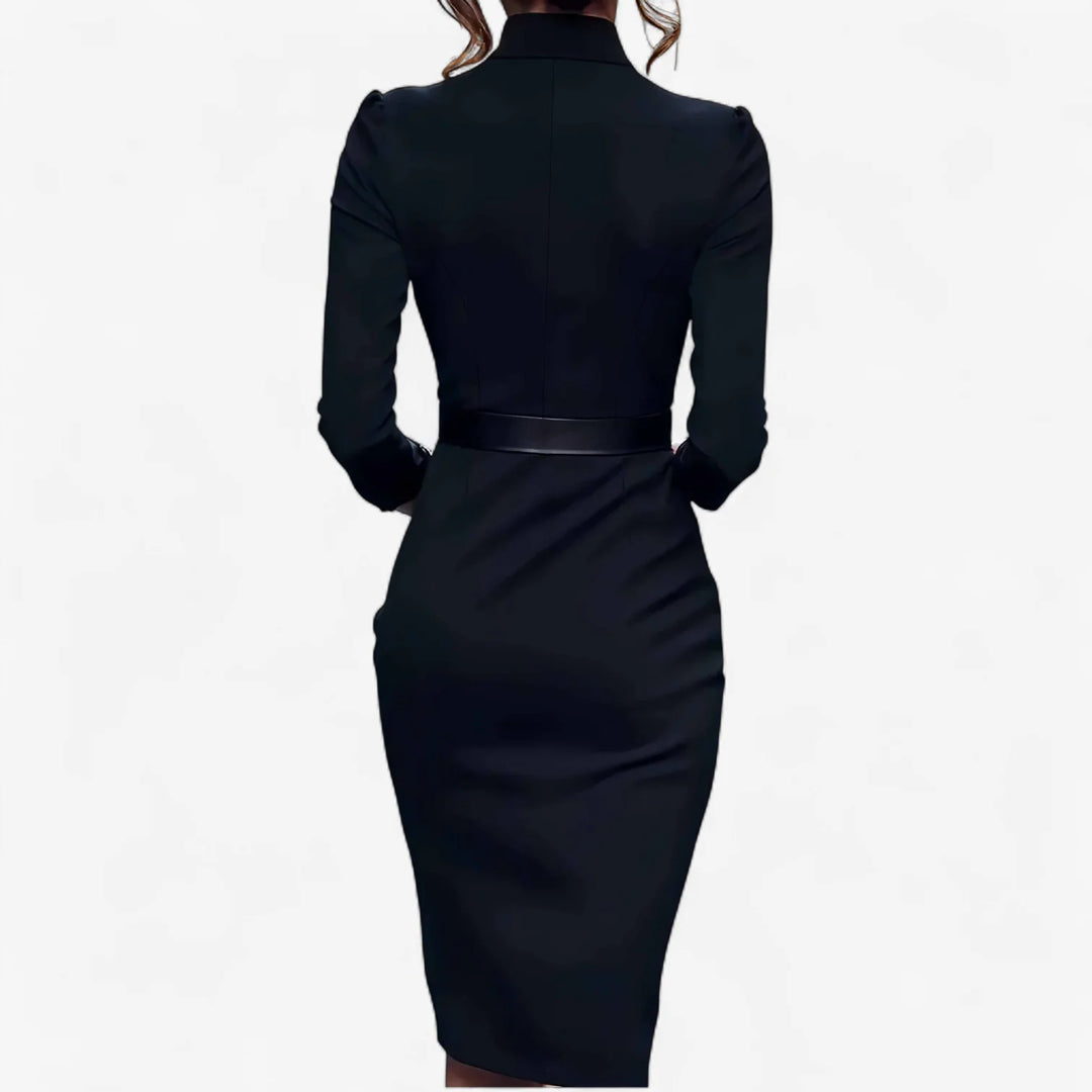 Close-up of belted midi dress showing tailored V-neckline and structured bodice with puff shoulders