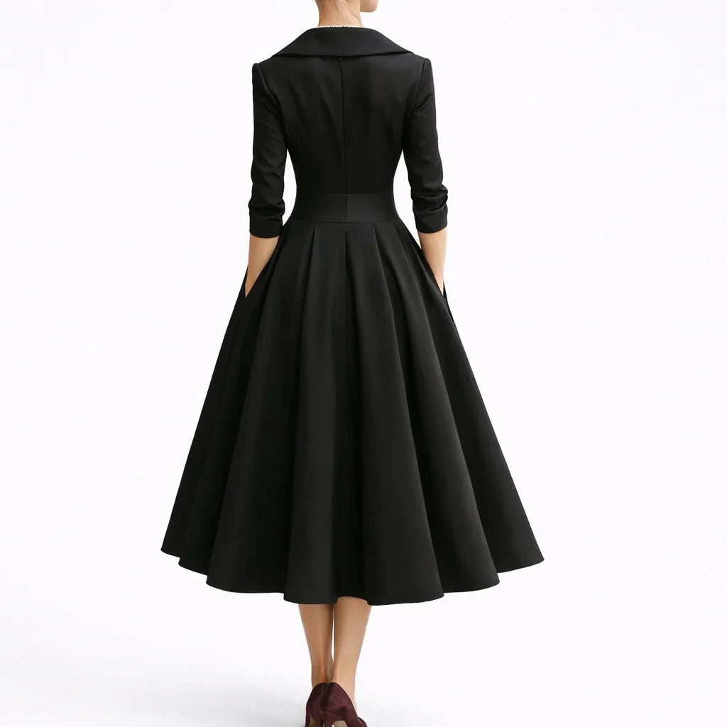 Side view of collared midi dress showing three-quarter sleeves and full skirt silhouette