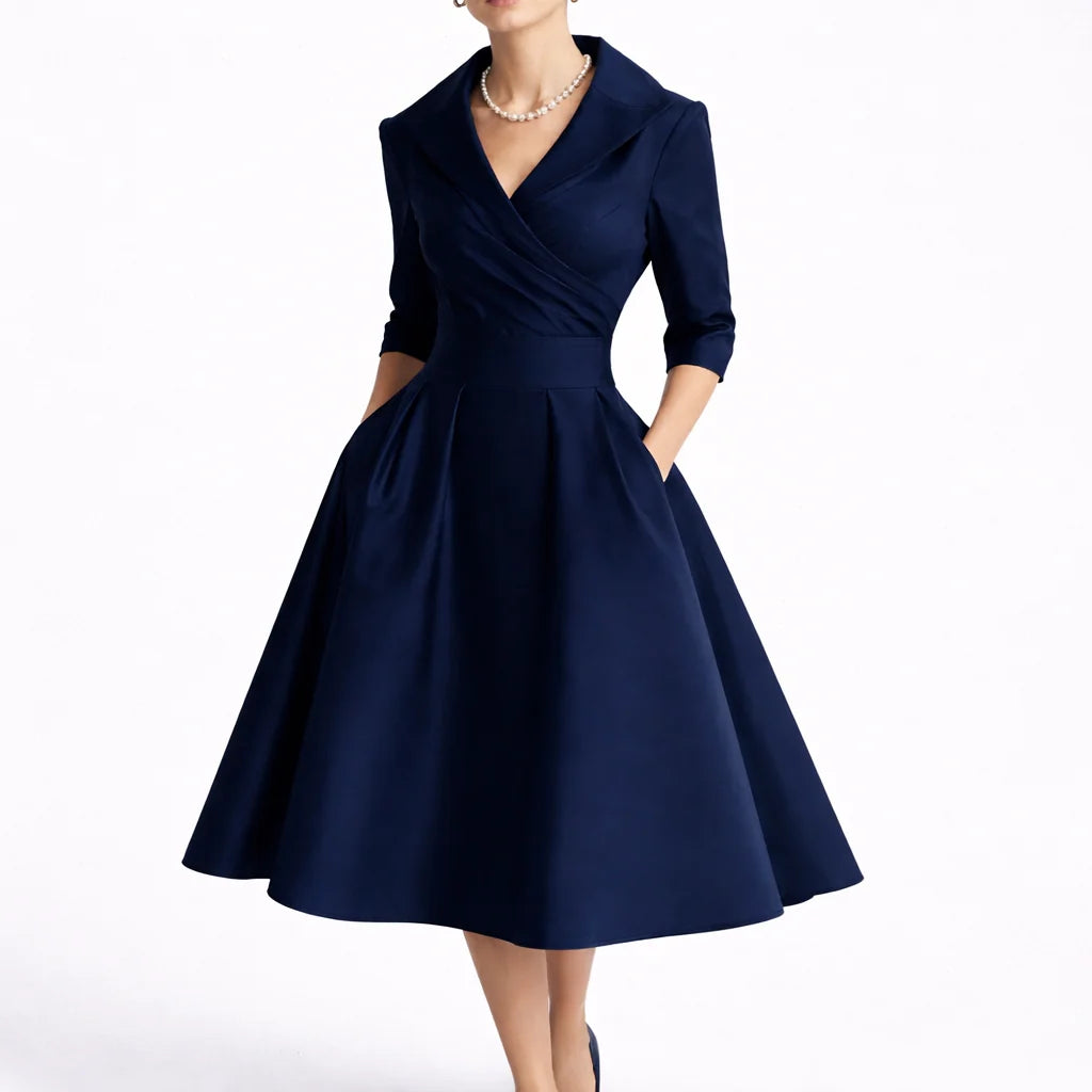 Close-up of wrap bodice detail on collared midi dress with structured fabric