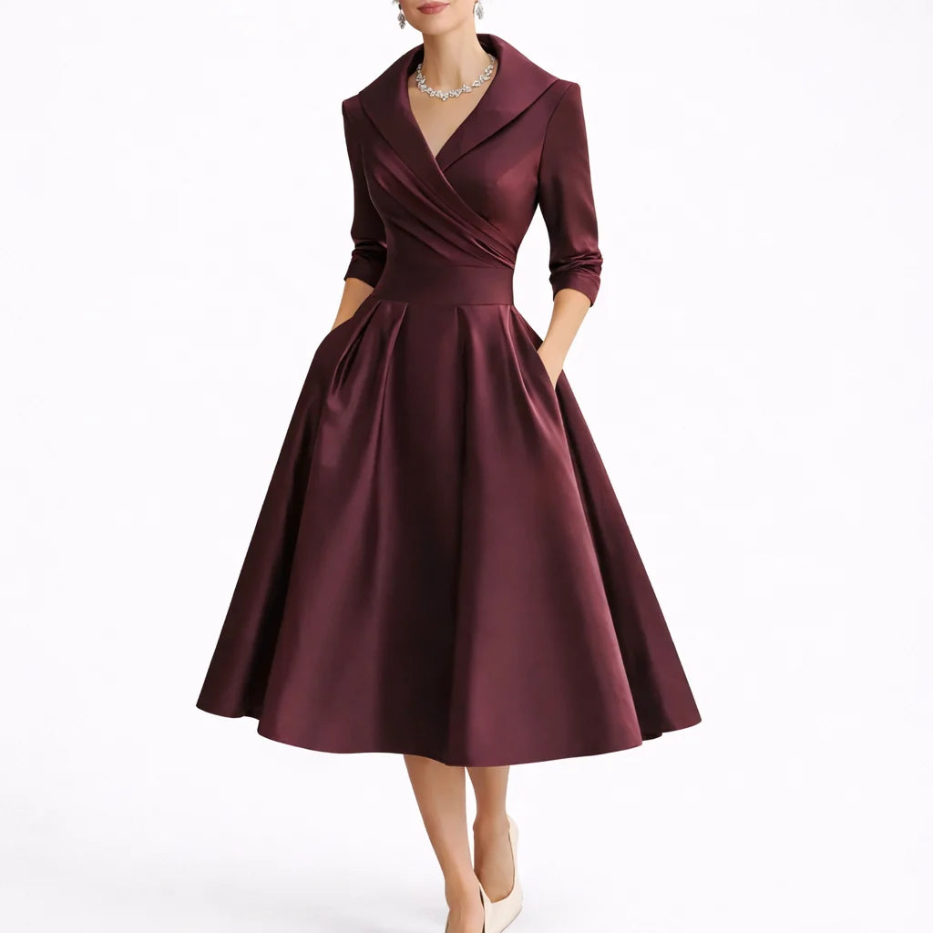 Model wearing collared midi dress styled with statement jewellery for formal occasions