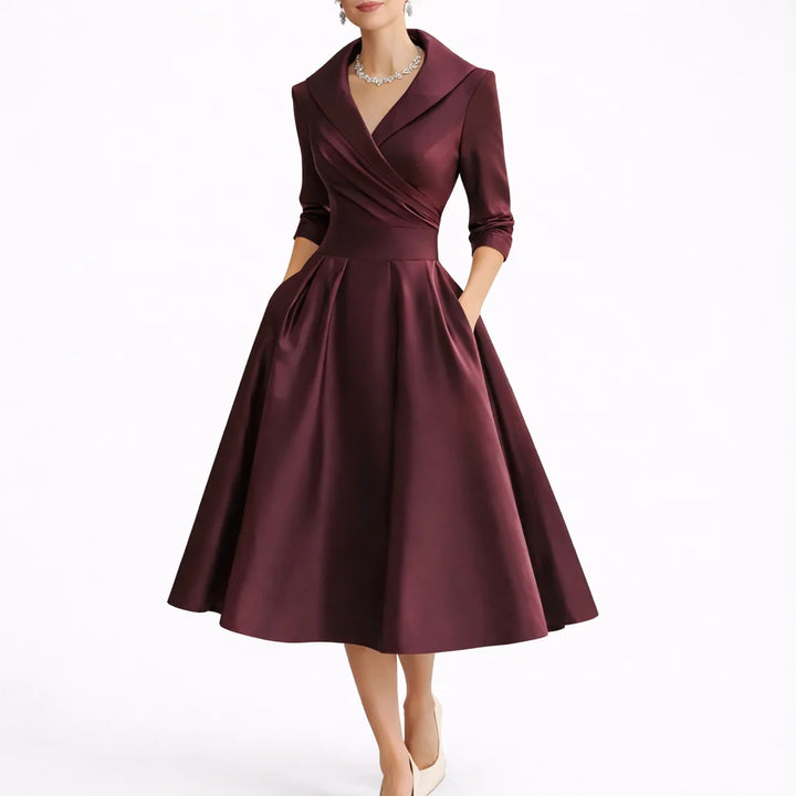 Model wearing collared midi dress styled with statement jewellery for formal occasions