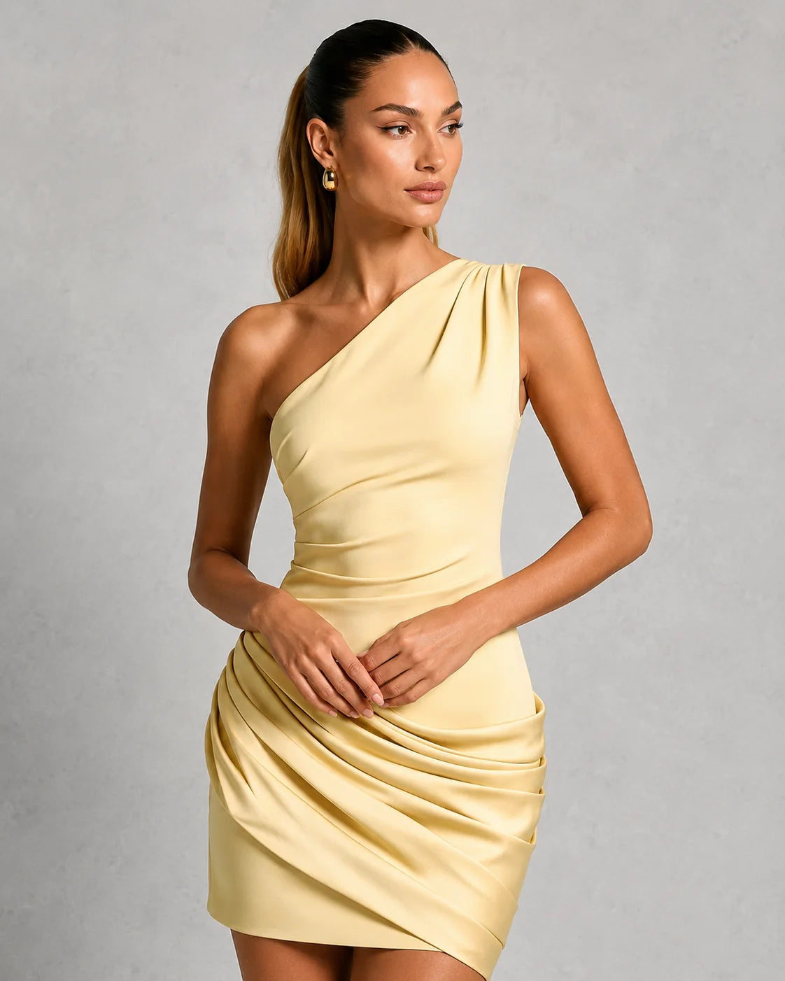 Full-length view of light blue fitted mini dress with asymmetric neckline and draped pleating