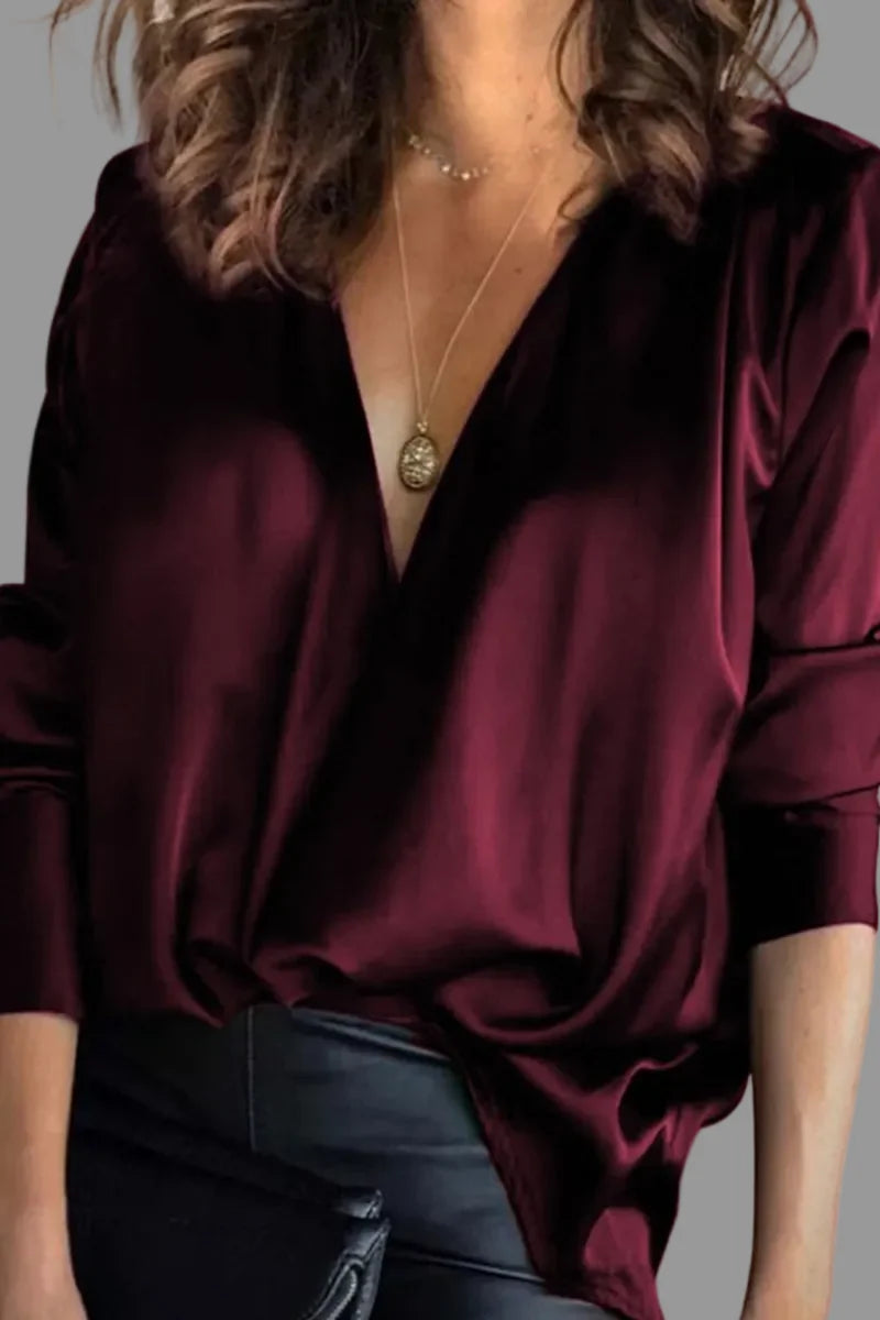 Close-up of satin blouse showing smooth fabric finish and flowing drape