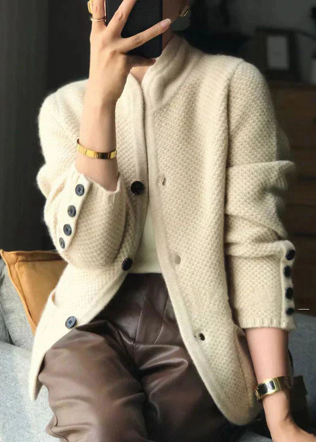 Side angle of women's cardigan in cream with high neckline and full-length sleeves