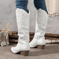 Rear view of women's knee-high cowboy boots in white with embroidered western detailing and block heel