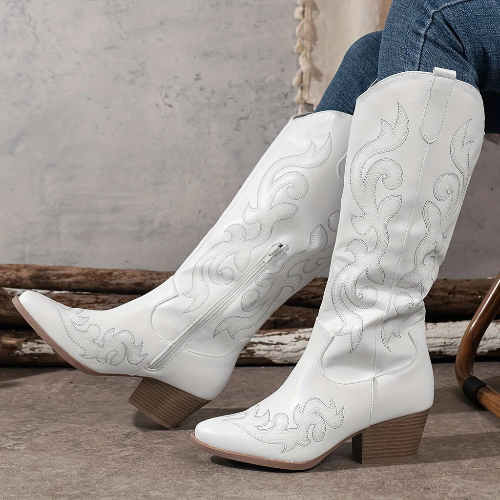Close-up of pointed toe and embroidered shaft on women's western-inspired knee-high boots