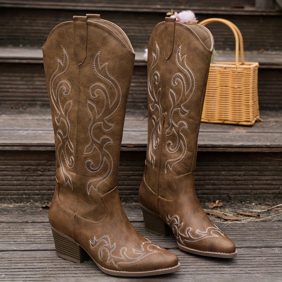 Rear angle of knee-high cowboy boots showing embroidered detailing and block heel profile