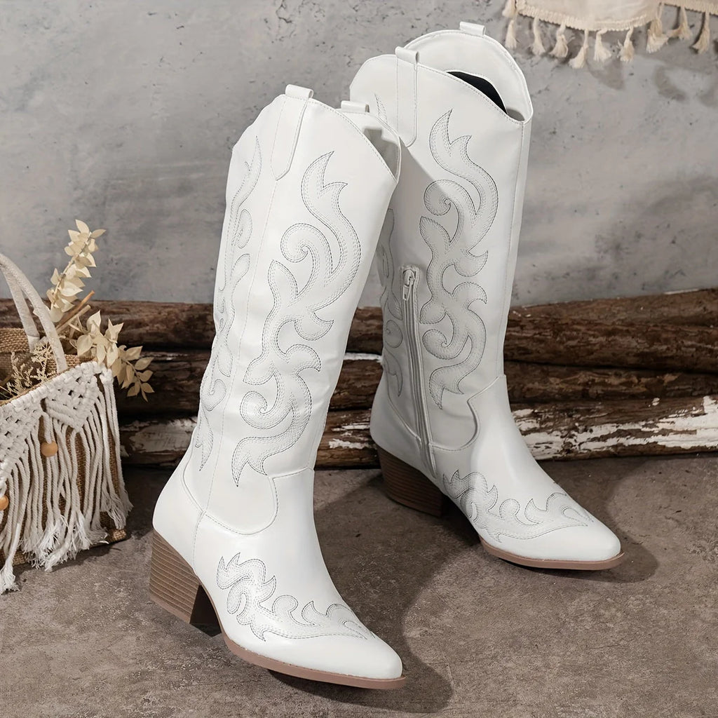 Three-quarter view of white cowboy boots highlighting pointed toe and stacked block heel