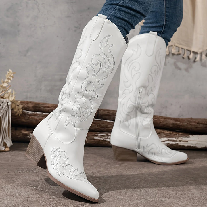 Overhead view of white cowboy boots showing pointed toe construction and decorative stitching