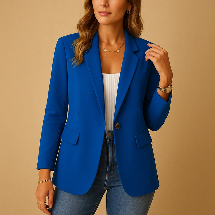 Women's tailored blazer in pink worn over ribbed knit top with dark denim trousers