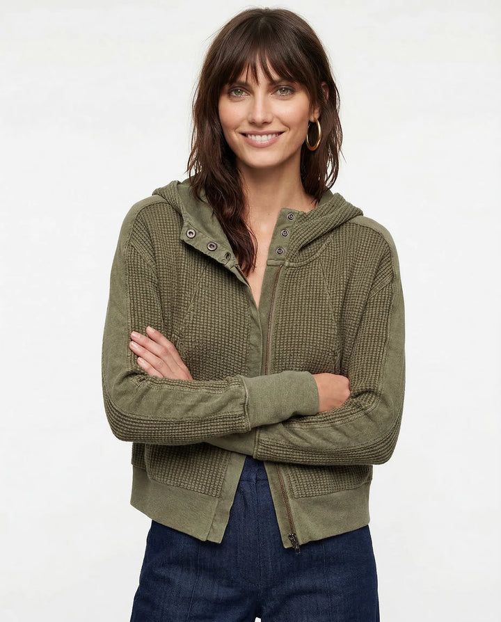Front view of textured waffle knit hoodie with full-length zip closure and relaxed fit silhouette