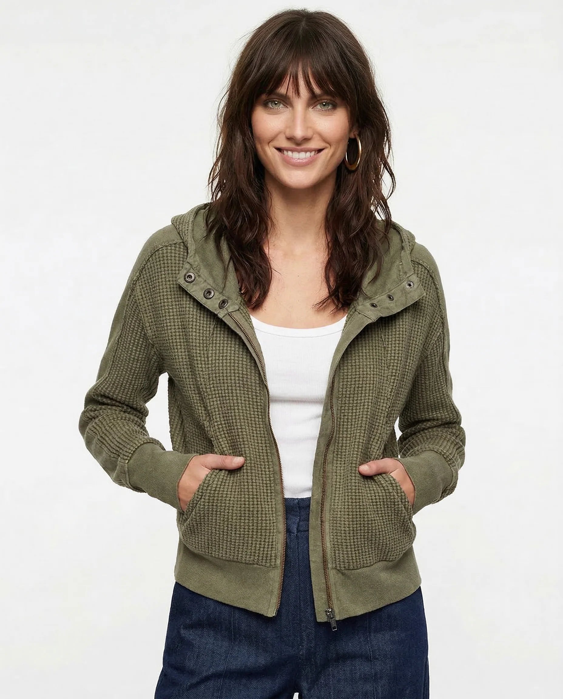 Side profile of women's zip-up hoodie featuring attached hood and casual everyday layering design