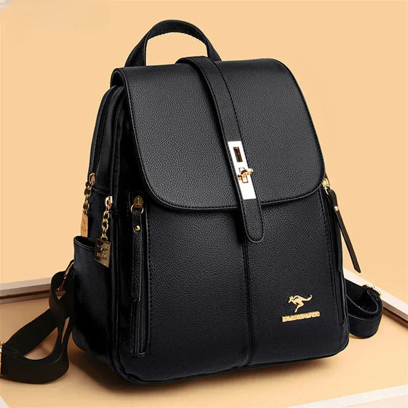 Men's leather backpack in black with structured silhouette, flap-over closure, and metal buckle detail on beige background