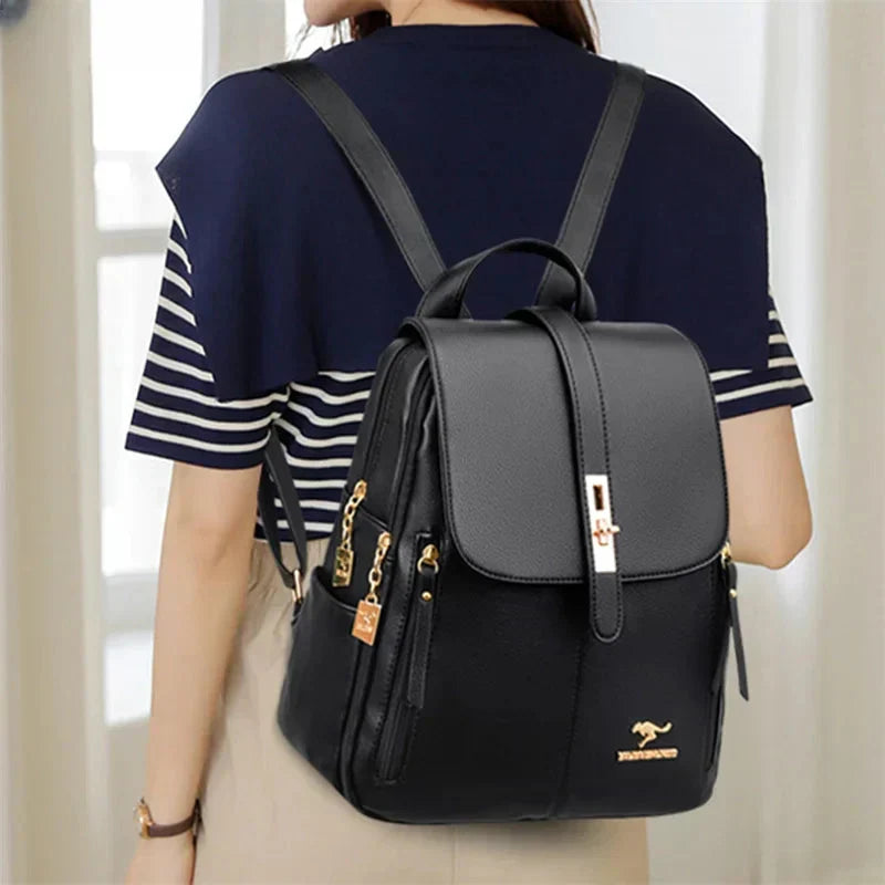 Men's black leather backpack shown from rear angle highlighting adjustable padded shoulder straps