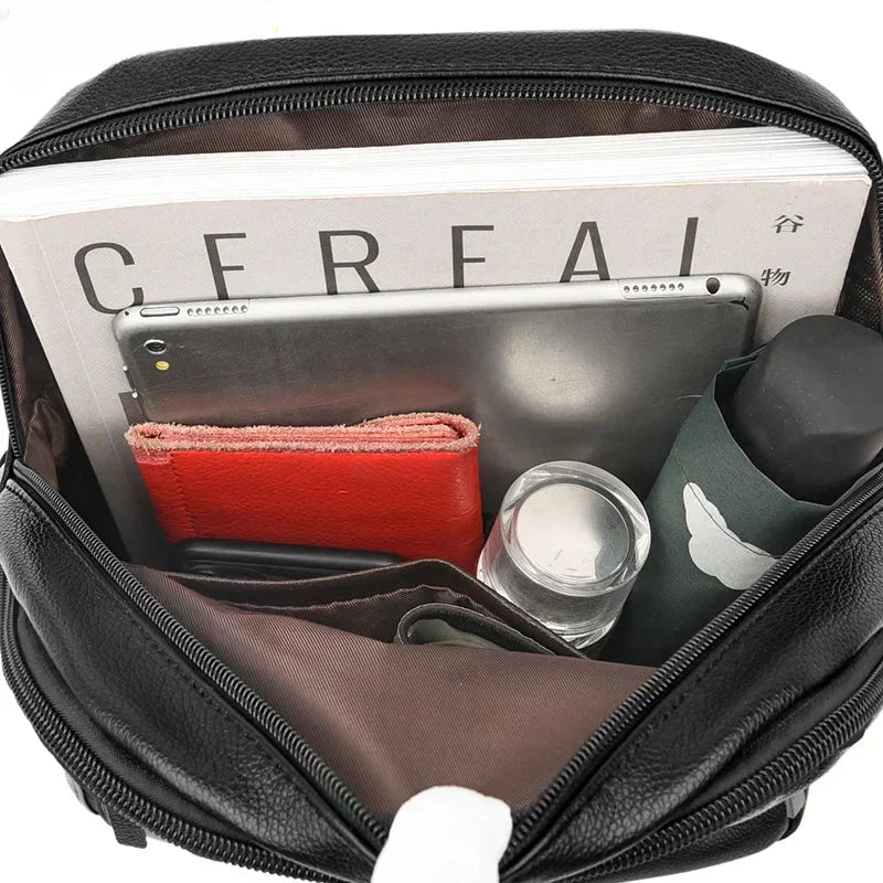 Full view of compact men's leather backpack demonstrating organised compartment layout and refined design