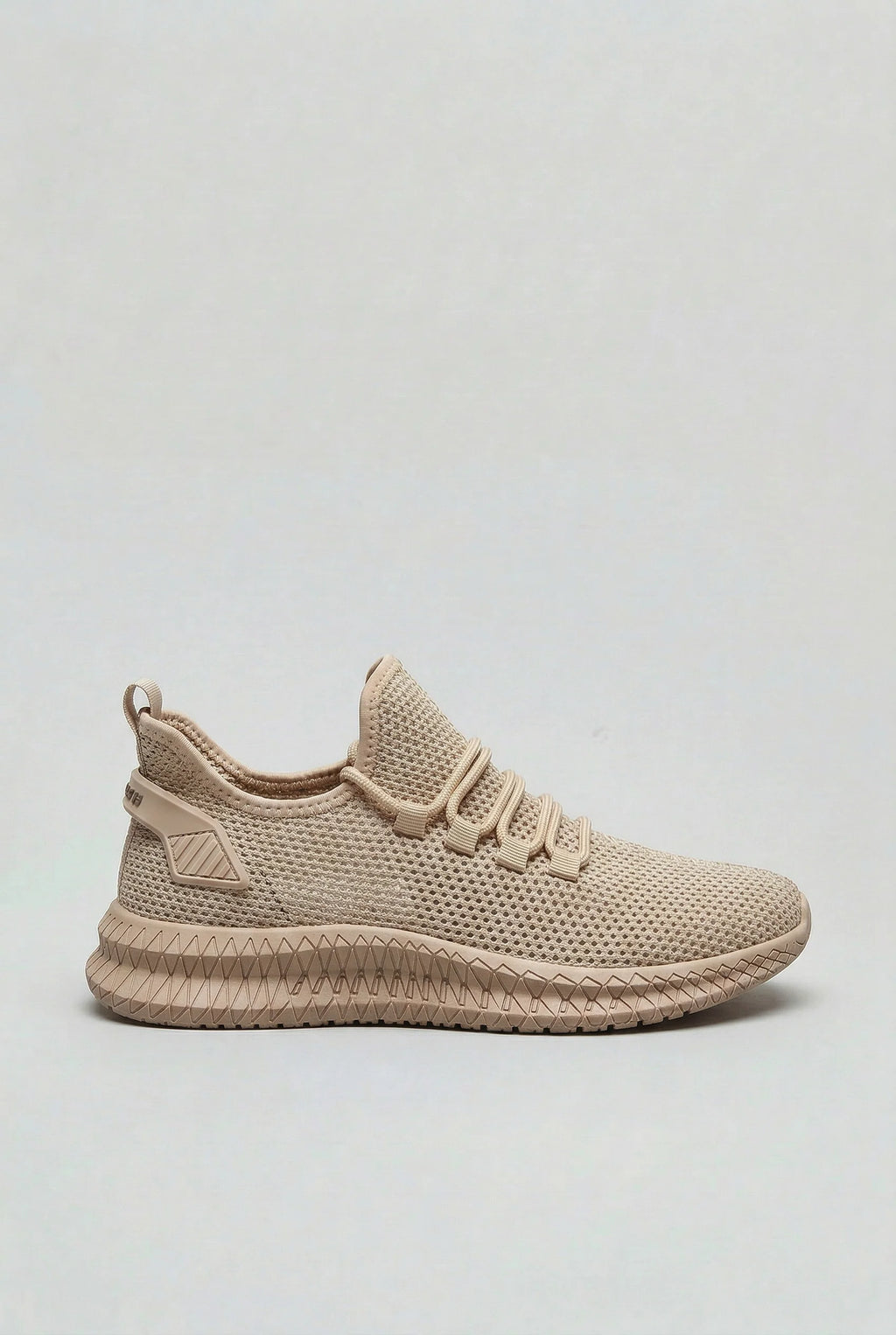 Side view of men's mesh trainers in sand with textured cushioned sole and lace-up closure
