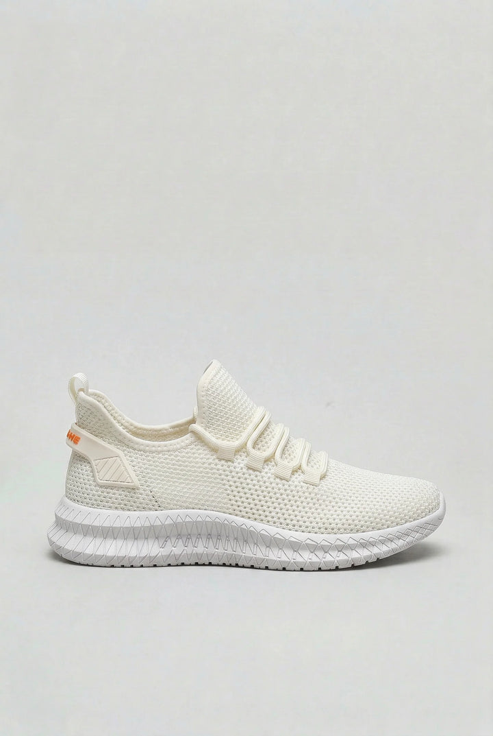 Close-up of men's mesh trainers showing open-weave fabric and cushioned sole texture