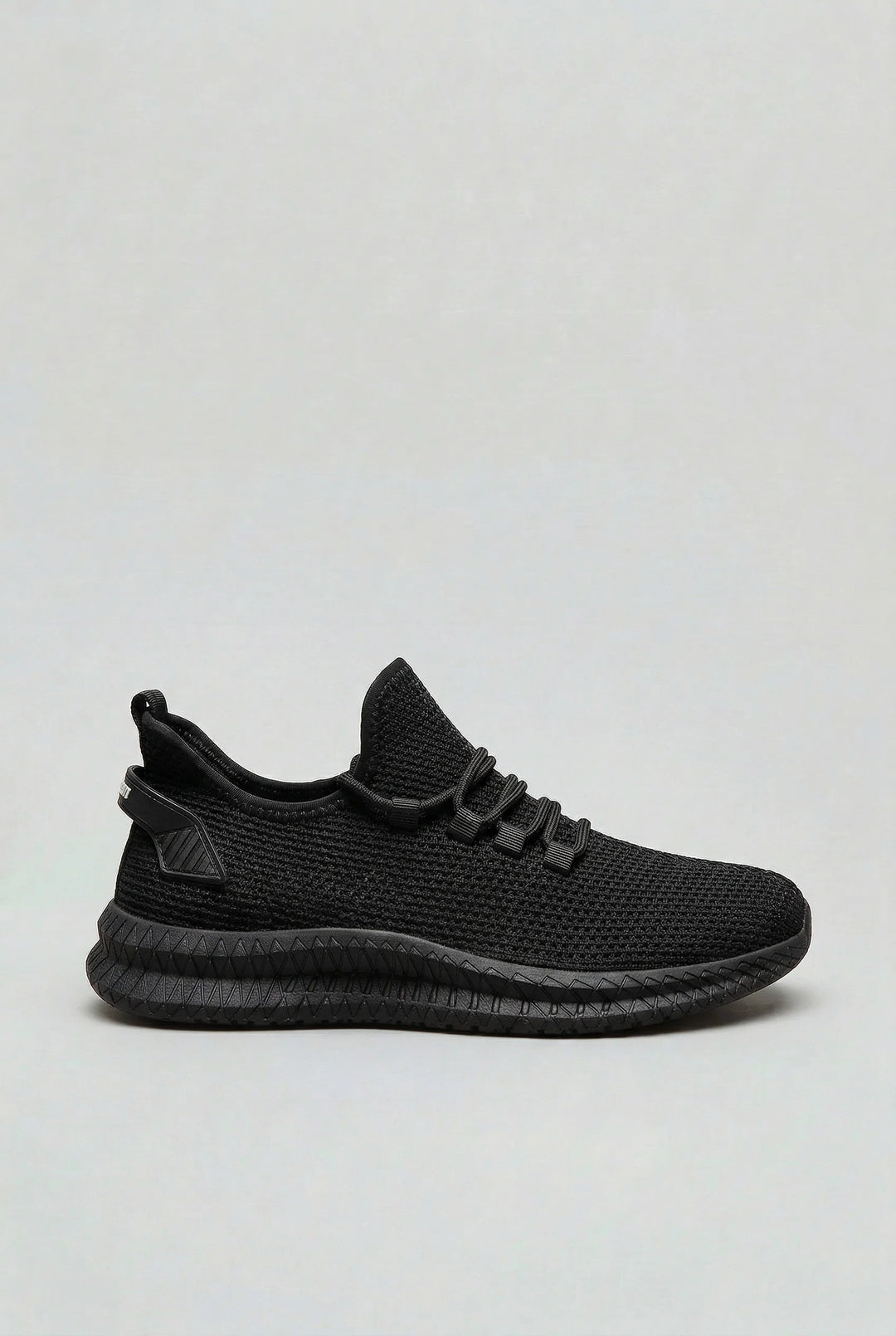 Full side profile of men's mesh trainers in neutral sand colourway with athletic silhouette