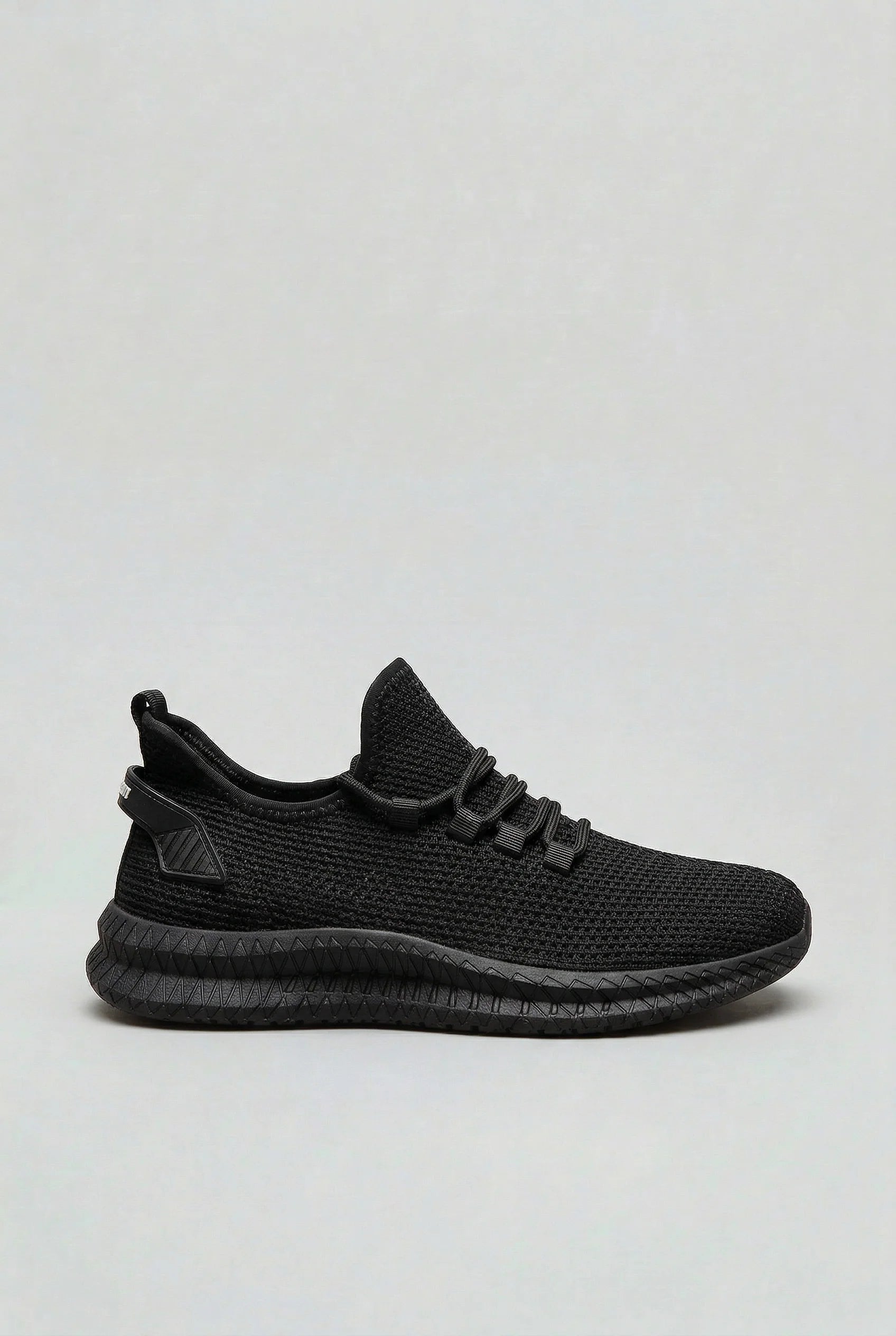 Full side profile of men's mesh trainers in neutral sand colourway with athletic silhouette