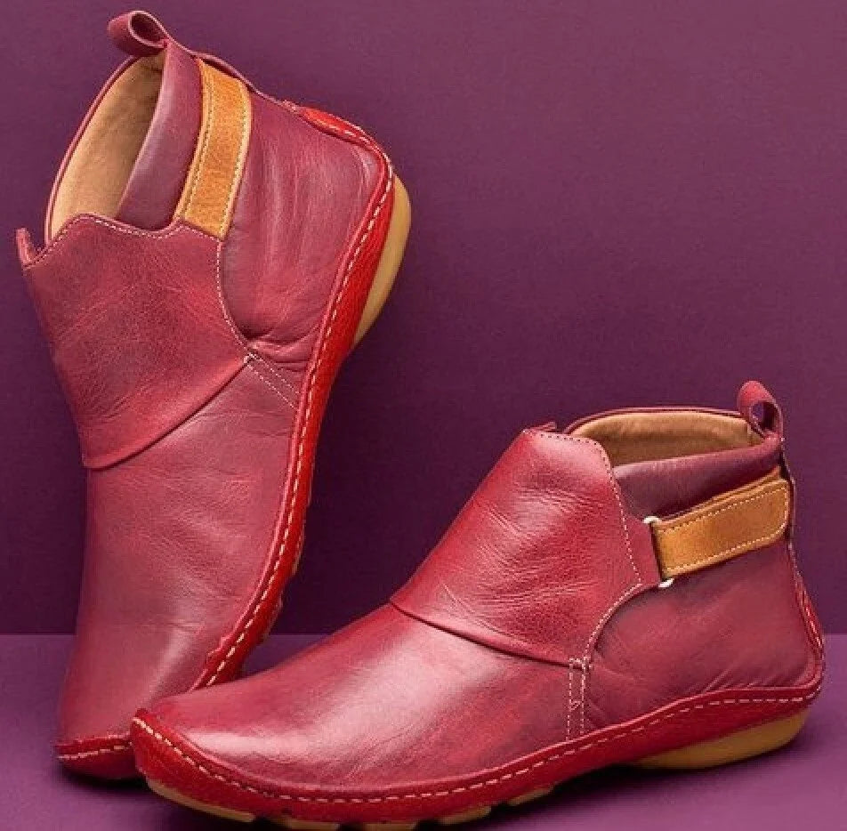 Women's ankle boots in burgundy with elasticated side panels and contrast stitching detail on flat sole