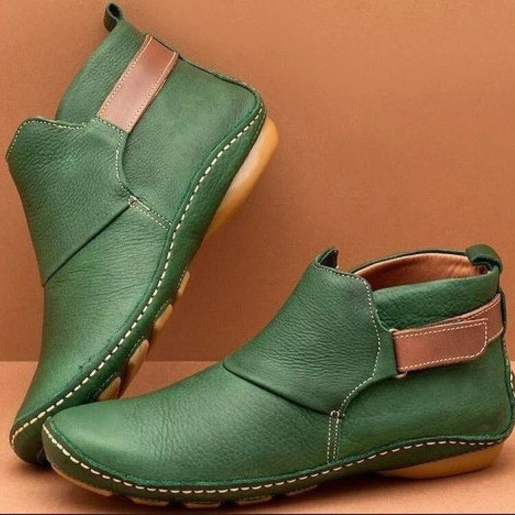 Detail of slip-on ankle boots showing smooth finish and flexible side panel construction
