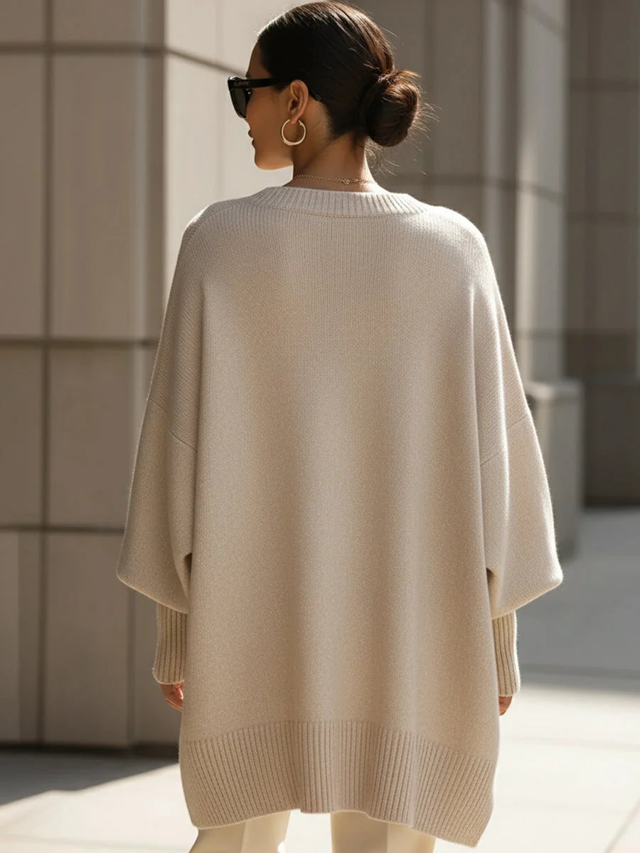Woman styling the oversized jumper with wide-leg trousers for casual elegance