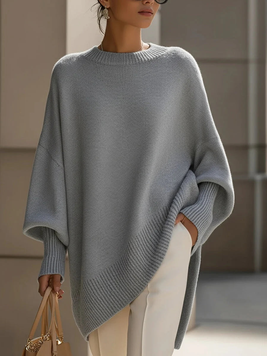 Woman wearing the oversized jumper in beige, showing the relaxed silhouette and dropped shoulders
