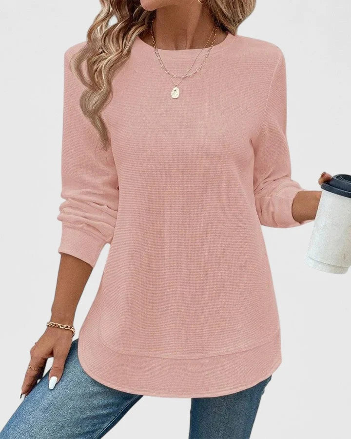 Close-up of ribbed knit texture on women's jumper showing vertical ribbed detail and crew neckline