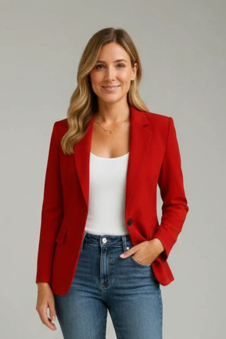 Red women's tailored blazer showing structured shoulders and hip-length cut with side pockets