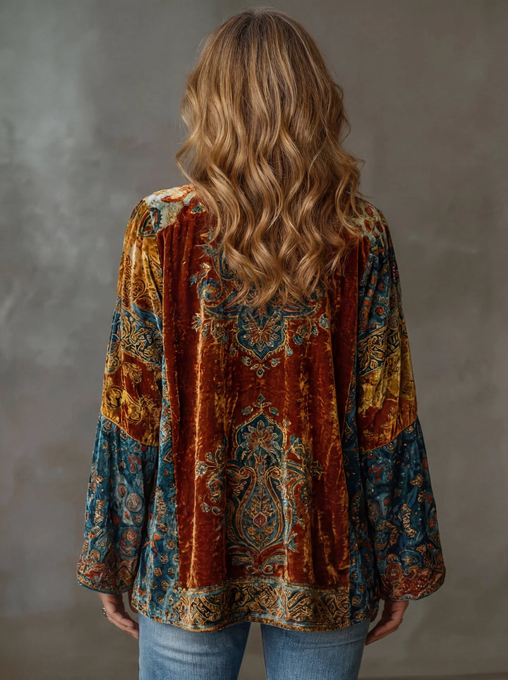 Side view showing the relaxed open-front silhouette and wide sleeves of the velvet bohemian cardigan draped elegantly