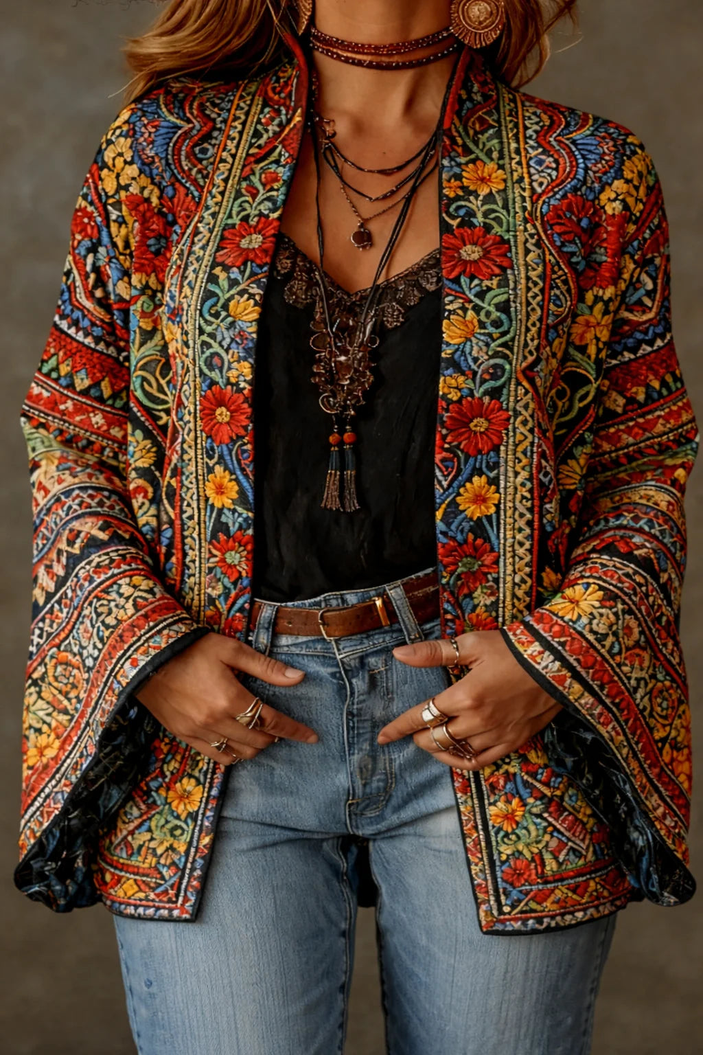 Detail of the rich tapestry-inspired pattern featuring warm rust, teal, and gold tones on the velvet-touch cardigan