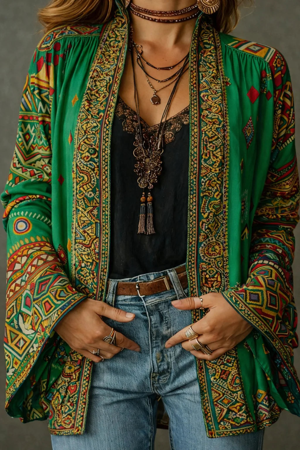Detail shot of the decorative trim along the front edges and intricate tapestry pattern on the cardigan