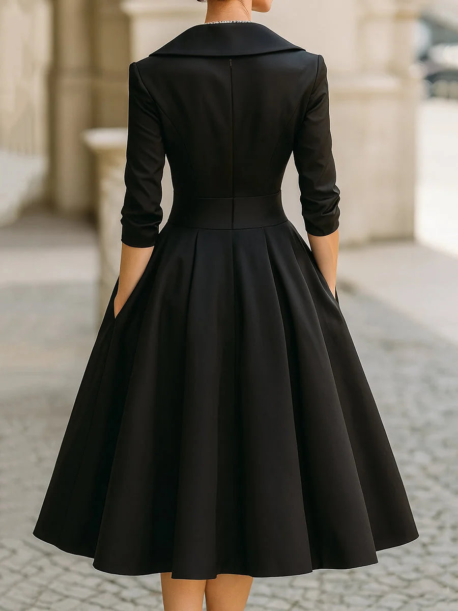 Close view of wrap bodice midi dress showing ruched waist detail and three-quarter sleeves