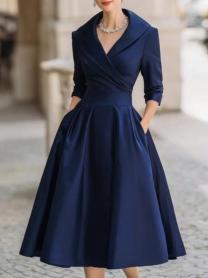 Side angle of midi dress with full pleated skirt and side pockets