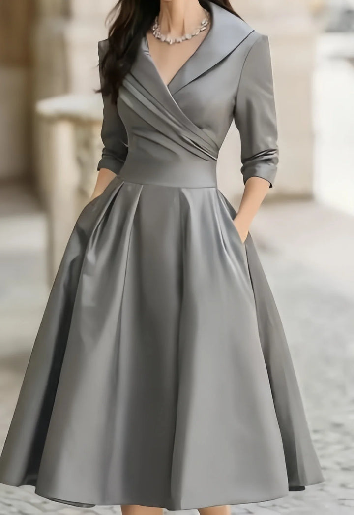 Three-quarter sleeves and ruched bodice detail on wrap midi dress