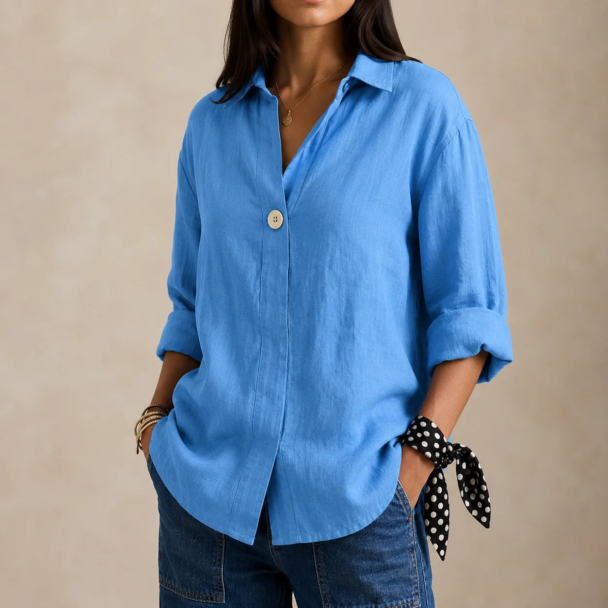 Relaxed linen blouse worn loose over trousers demonstrating versatile styling options